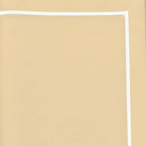 :
Close up of white embroidered details on gold cotton tablecloth