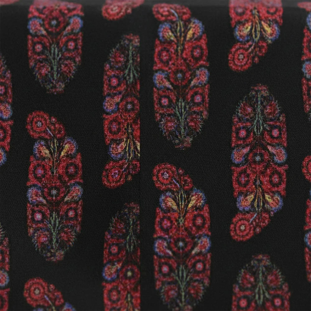 Black and red floral block print tablecloth draped on dining table