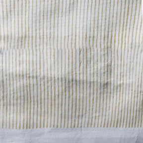 Neutral-toned block print tablecloth creating a warm and inviting table setup