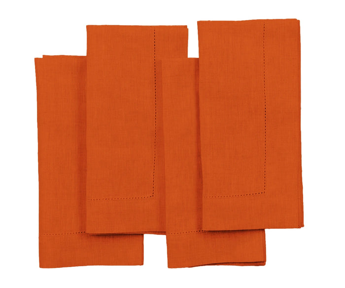 A set of orange linen napkins with a hemstitch pattern.
