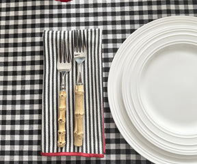 Black and red striped cloth napkins adding contrast to a festive table décor setup.