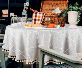 A round tablecloth with an intricate paisley design in warm earthy tones.