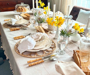 Beige tassel tablecloth highlighting textured fabric and tasseled border design