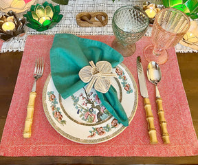  Enhance your dining table with vibrant red fabric placemats, combining elegance and protection for a delightful mealtime ambiance.