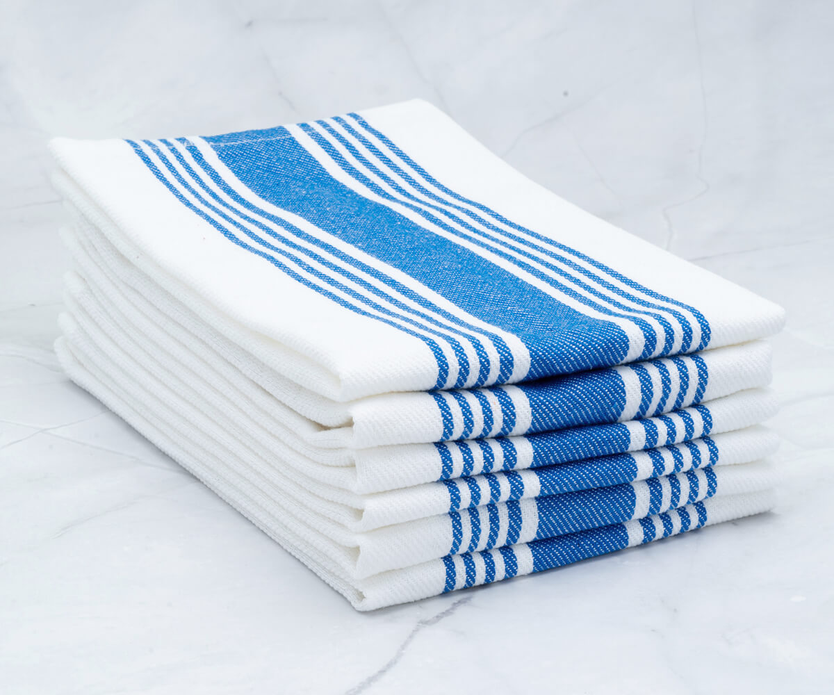 Blue napkins elegantly folded to complement a romantic dinner setup.