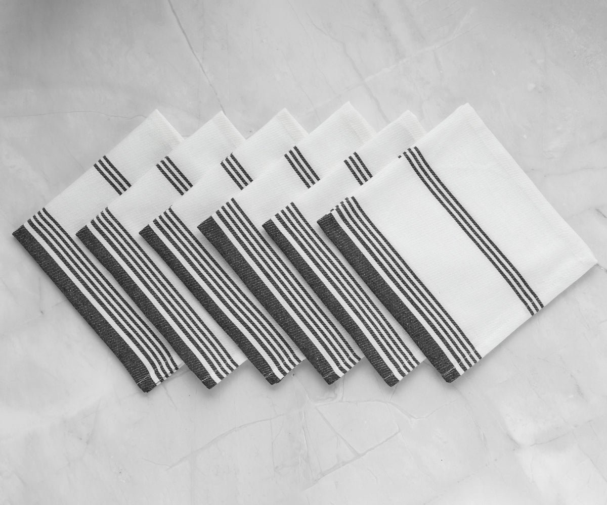 Black and white striped napkins folded on a table, monochrome image