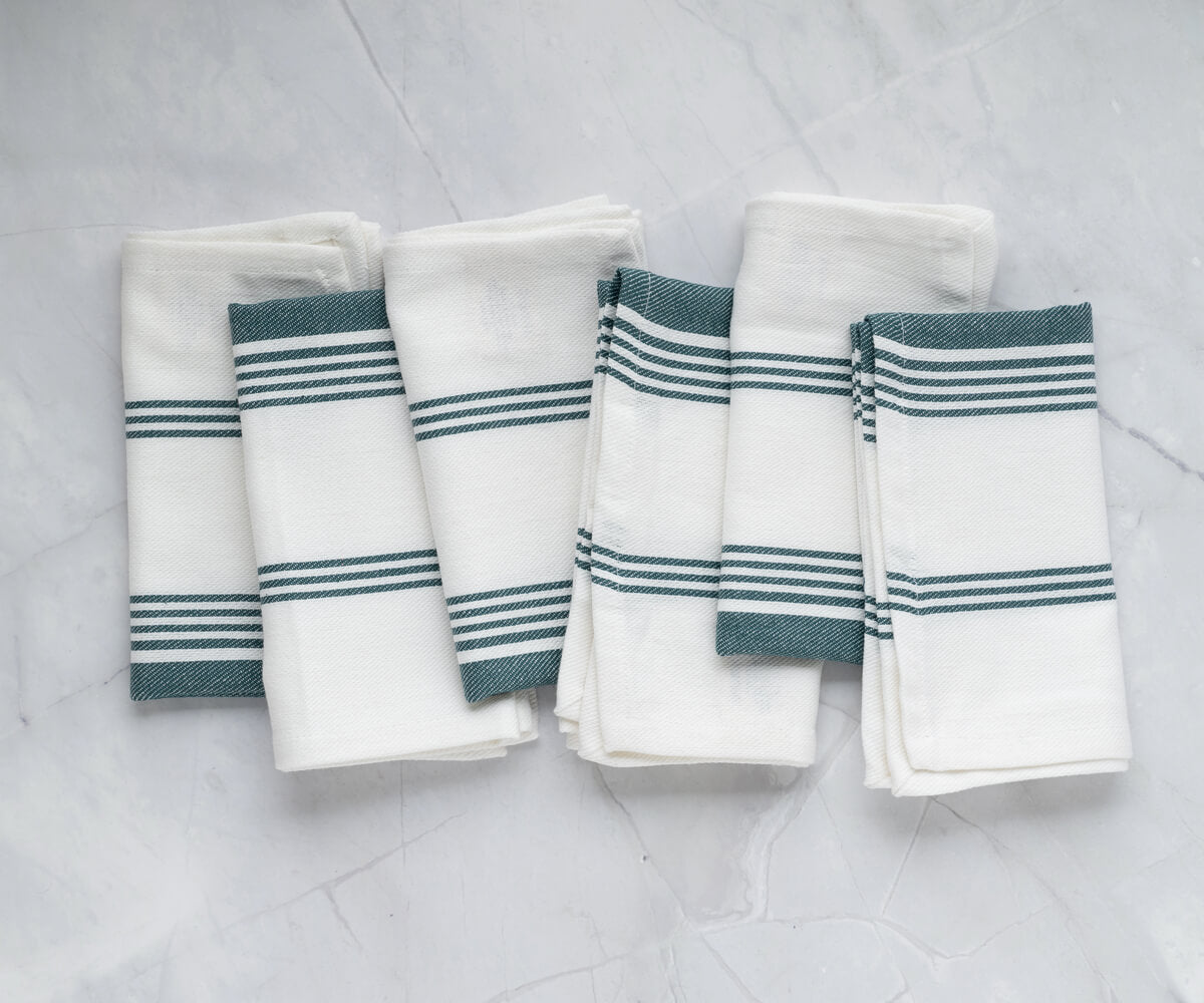 Set your table with soft sage green napkins, adding a natural touch.