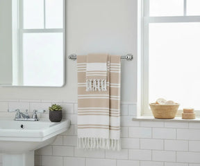 Set of 2 beige Turkish cotton beach towels with white stripes, soft, absorbent, and quick-drying for bath or beach use.