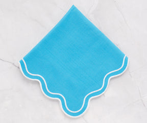 Turquoise scalloped napkins paired with a matching scalloped tablecloth, elegant 100% cotton napkins for weddings, parties, and everyday meals