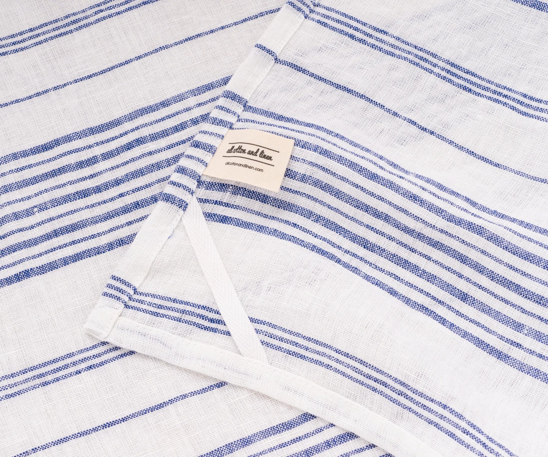 Blue kitchen dish towel drying plates and glasses