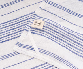 Blue kitchen dish towel drying plates and glasses