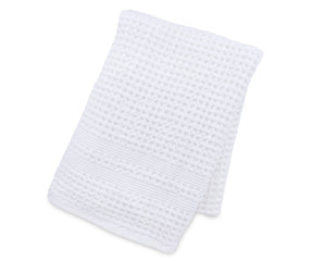 Soft waffle weave blanket draped over a couch for a modern home décor touch.