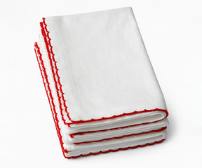 Set of white cotton napkins with red trim detailing, soft reusable cloth napkins ideal for festive table settings and elegant home dining