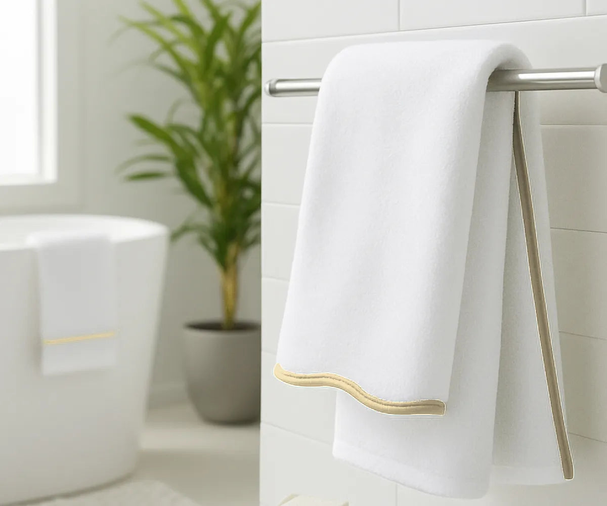 Luxury white and beige bath towels displayed on countertop for home or beach décor
