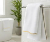 Luxury white and beige bath towels displayed on countertop for home or beach décor