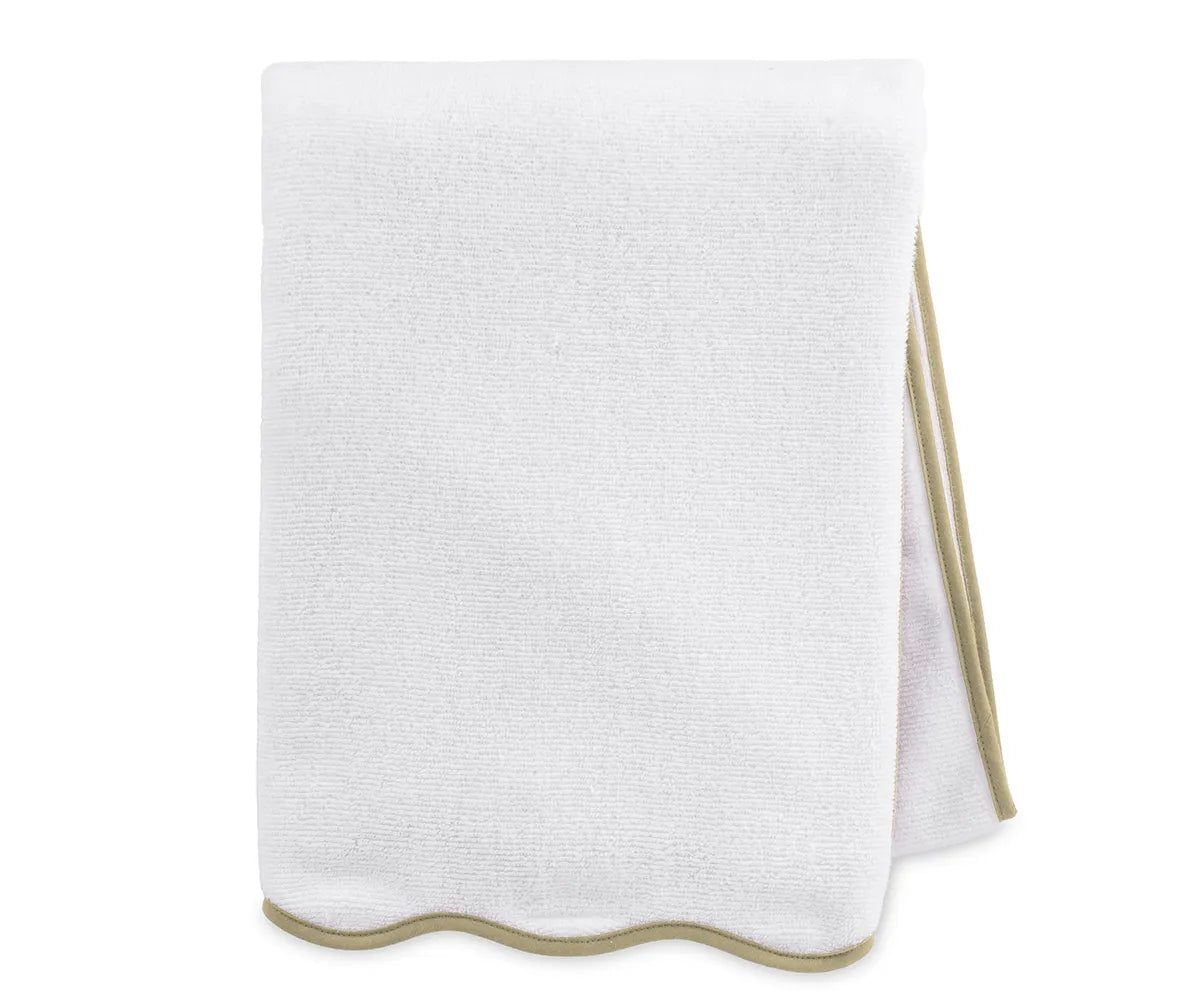 Close-up of white bath towel with beige trim highlighting soft, absorbent cotton weave
