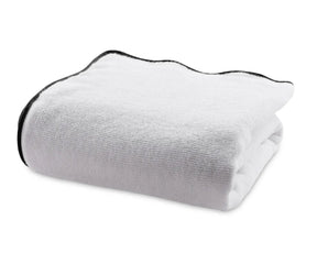 Premium quality white bath towel with refined black edge detailing, made from ultra-absorbent 100% cotton for a modern and sophisticated bathroom look.