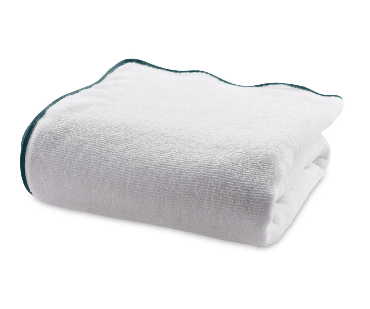 Close-up of green and white bath towel highlighting plush cotton weave and absorbency