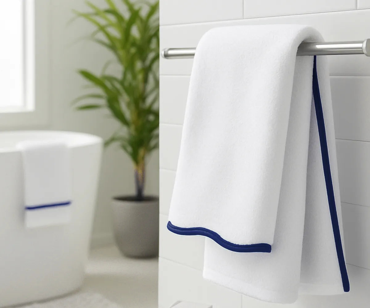Luxury navy and white striped bath towels displayed on a bathroom countertop for home décor