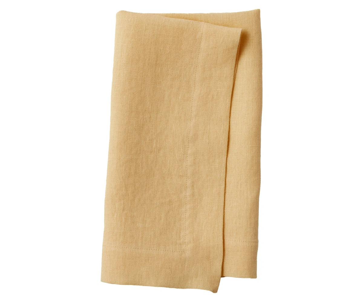 Bright yellow plain linen napkin displayed on a table, highlighting soft and durable fabric