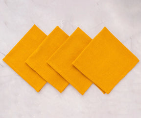 Reusable yellow cloth napkins paired with a yellow tablecloth.