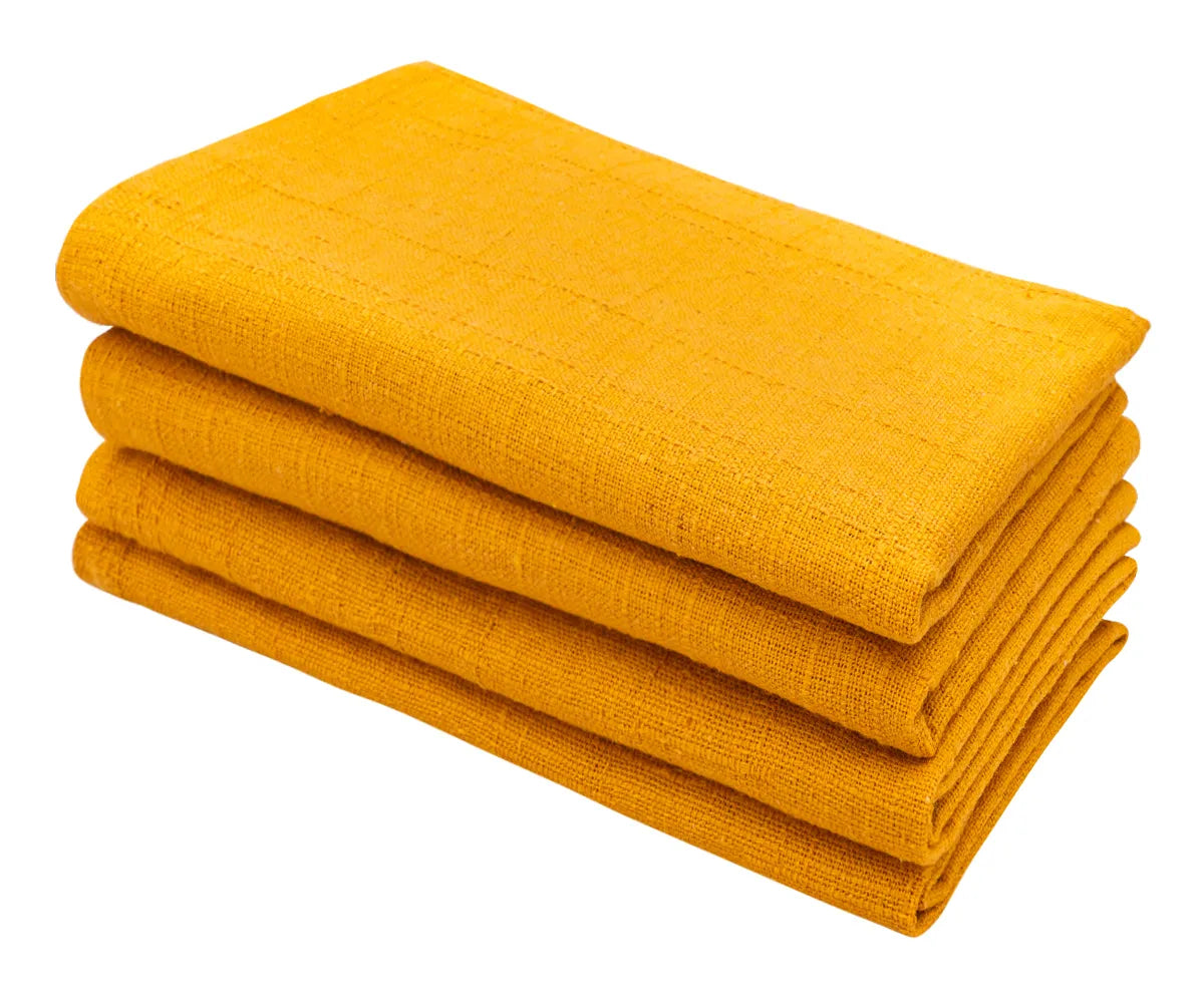 Bright yellow cotton napkins folded neatly on a dining table.