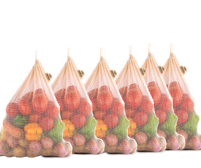 A set of six cotton string bags, each loaded with fruits and vegetables