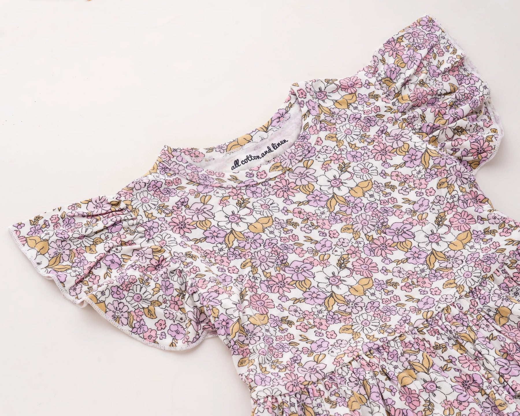 Adorable pink floral cotton dress for baby girls, designed as a breathable sleeveless outfit ideal for warm weather and daily wear, with a timeless charm inspired by vintage baby clothes styles.