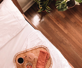 Bed setup with cotton fitted sheet and breakfast tray
