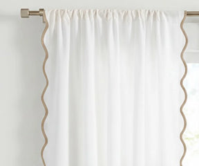 White scalloped curtain panel with beige trim