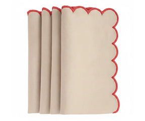 Decorative scalloped dinner napkins with red trim border