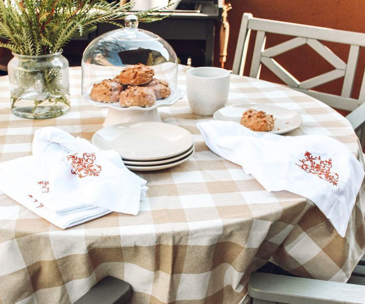 Dress up your table with a classic touch: white, red, and buffalo plaid tablecloths, perfect for adding style and charm to any occasion.