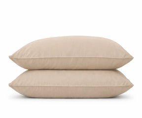 A stack of two beige pillow covers in a soft cream tone, perfect for minimalist bedroom styling and neutral home decor.