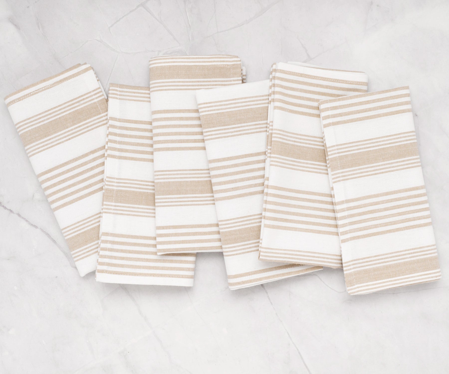 Striped cotton cloth napkins in beige, folded stack