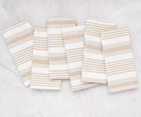 Striped cotton cloth napkins in beige, folded stack