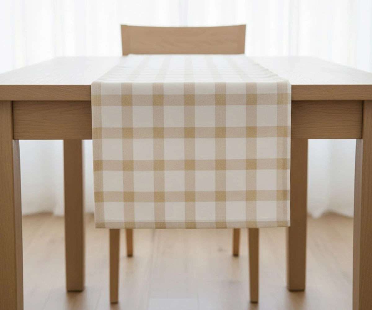 Beige and white check cotton table runner with light yellow accents adding rustic elegance and warmth to a festive dining table.
