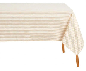 Rectangular beige and white horizontal striped cotton tablecloth draped over a wooden table against a white background.