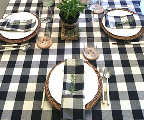 Dining table elegantly set with a black and white checkered tablecloth