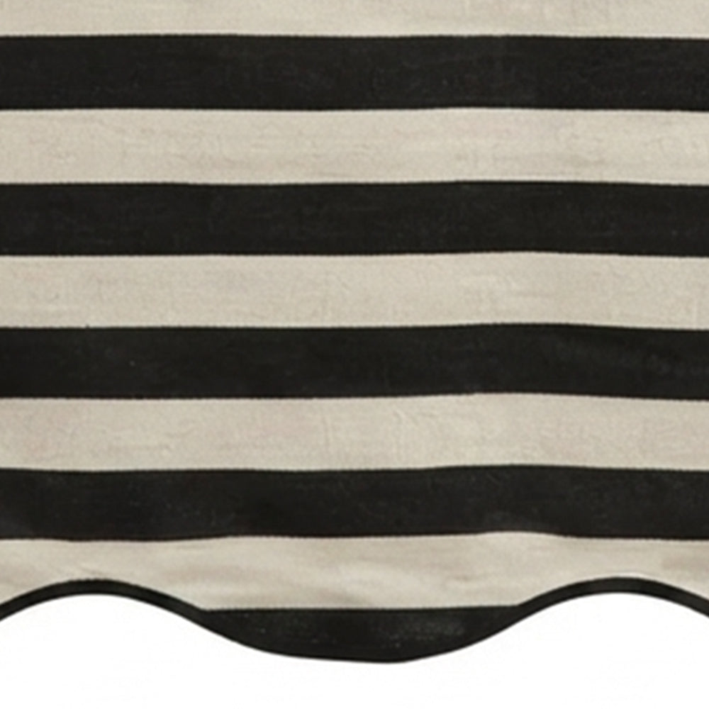 Black and white cabana striped table runner with a scalloped edge detail.