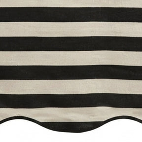 Black and white cabana striped table runner with a scalloped edge detail.