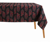 Dark floral block print cotton tablecloth on wooden dining table