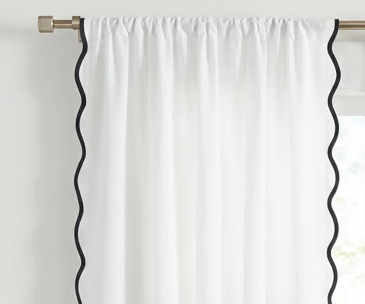White scalloped curtain panel with black trim