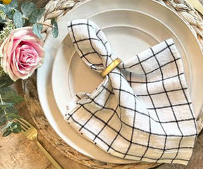 An image of black and white linen napkins used for a wedding reception, adds an elegant touch.