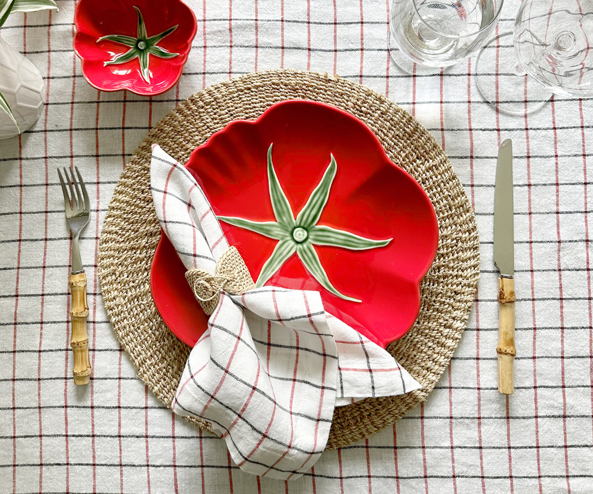 Elevate gatherings with a red and white checkered tablecloth, suitable for outdoors. Also, explore our holiday-themed tablecloths.