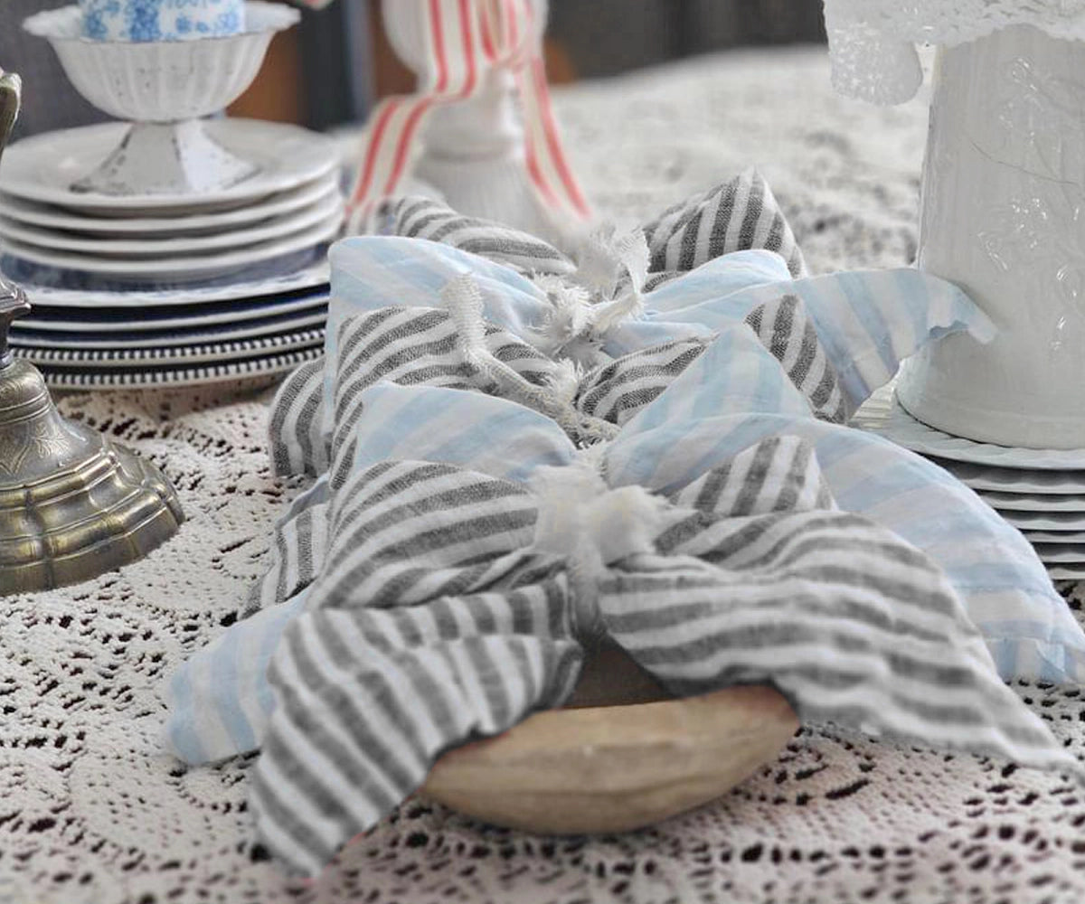 Black pinstripe linen napkins styled with elegant table decor for modern dining spaces