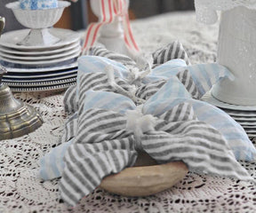 Black pinstripe linen napkins styled with elegant table decor for modern dining spaces