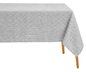 Rectangular black and white horizontal striped cotton tablecloth draped over a wooden dining table.