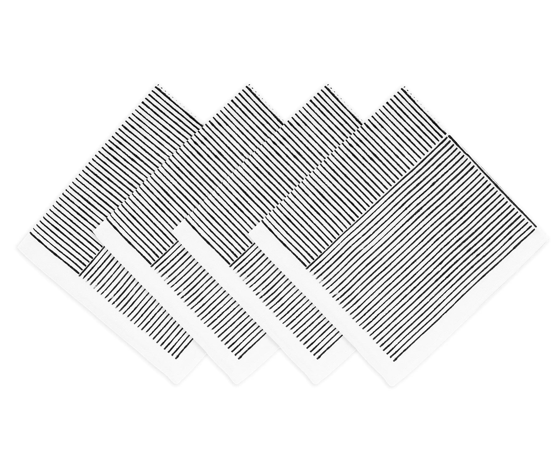 Hand-block printed napkins folded beside ceramic dinnerware	