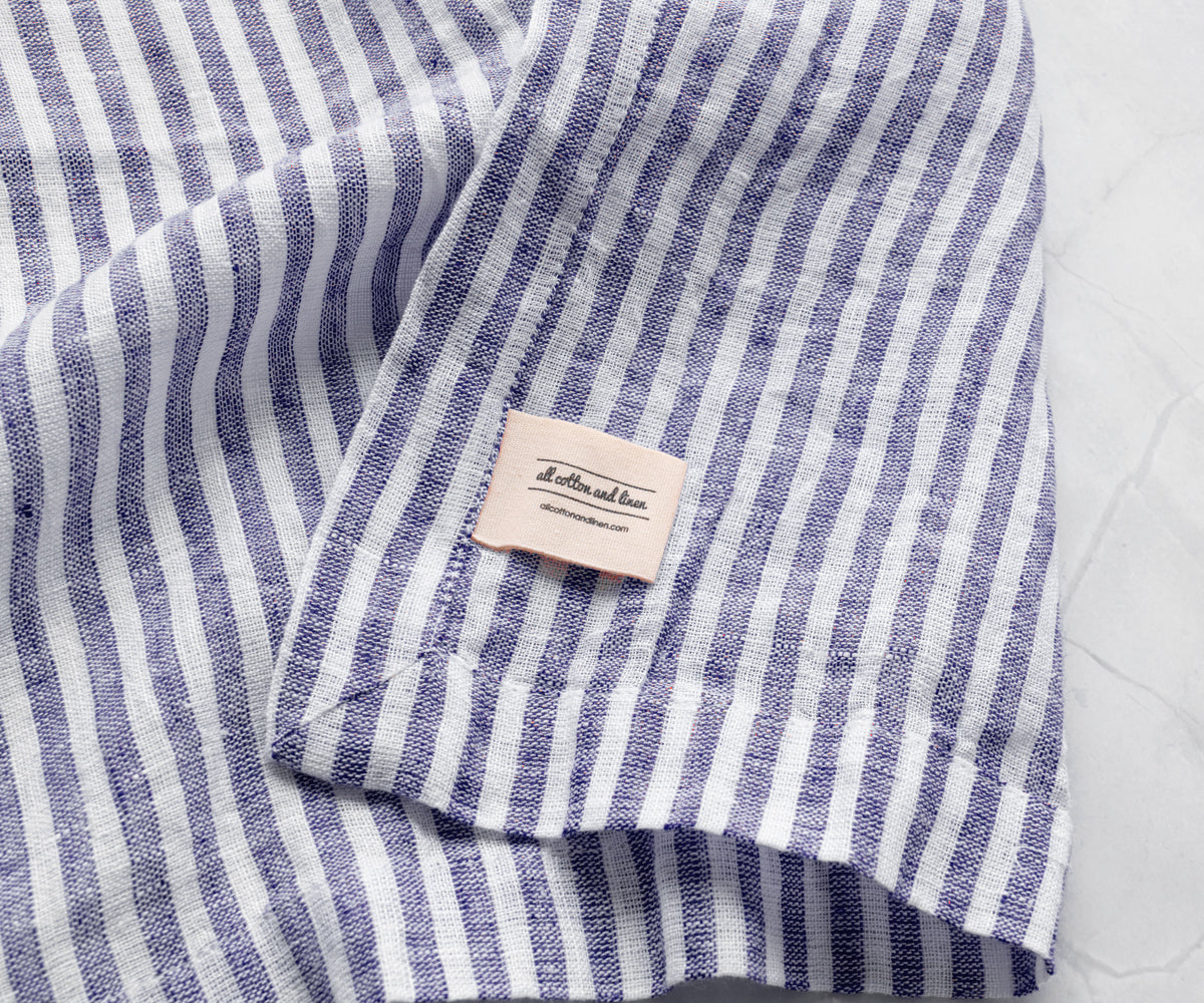 Blue pinstripe linen napkins styled for baby shower tables with elegant and coordinated event décor