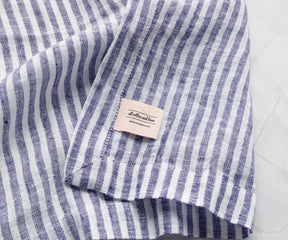 Blue pinstripe linen napkins styled for baby shower tables with elegant and coordinated event décor